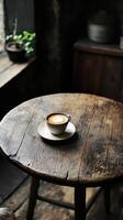 A wooden table with a cup of coffee sitting on it photo