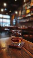 A glass of whiskey on a wooden table in a restaurant photo