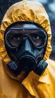 A man in a yellow rain suit and gas mask photo