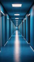A long hallway with blue walls and doors photo