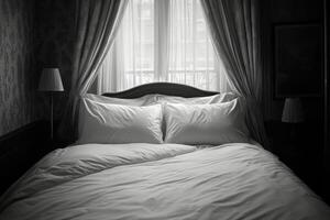 A black and white photo of a bed with white pillows