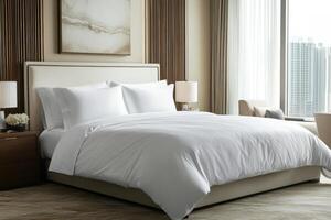 A large bed with white sheets and pillows photo