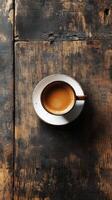 A cup of coffee on a wooden table photo