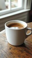 A cup of coffee sitting on a table photo
