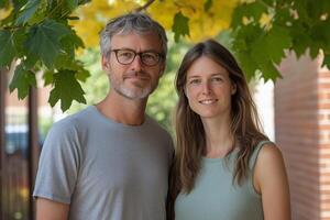 A man and woman standing in front of a tree photo