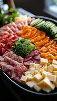 A platter of meat, cheese, vegetables and other food photo