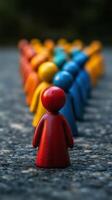 A group of wooden people standing in a line photo