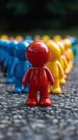 A group of colorful toy people standing in a row photo