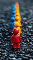 A red and blue person standing in a line with other people photo