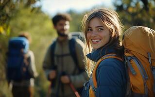A woman with a backpack and two men in the background photo