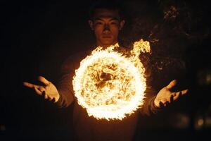 A man holding a fire ring in his hands photo