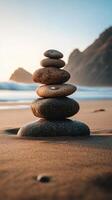 A stack of stones on the beach at sunset photo