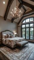 A large bedroom with a chandelier and a bed photo