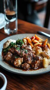 A plate of food with meat and vegetables on a table photo