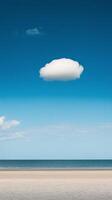 A lone cloud floats above the ocean in a blue sky photo
