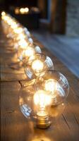A row of light bulbs on a wooden table photo
