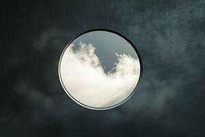 A circular window with a reflection of clouds photo