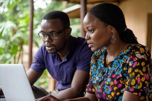 A man and woman looking at a laptop photo