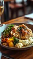 A plate of food with a glass of wine on a table photo