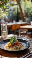 A plate of food on a table in an outdoor restaurant photo