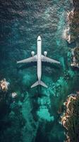Aerial view of airplane flying over the ocean photo