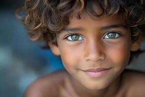 A young boy with curly hair and green eyes photo