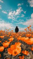 A person standing in a field of orange flowers photo