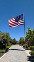An american flag flying in front of a house photo