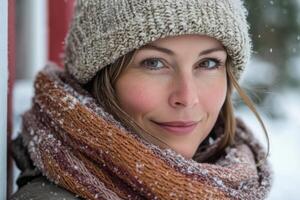 A woman wearing a hat and scarf in the snow photo