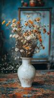 Dried flowers in a vase on a table photo