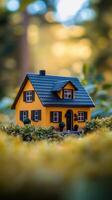 A miniature house is sitting on top of a green forest photo
