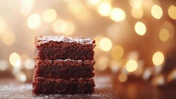 A stack of brownies on a table with lights photo