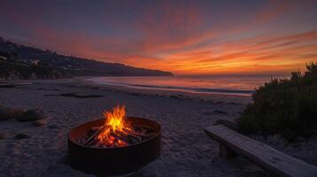 A fire pit on the beach at sunset photo
