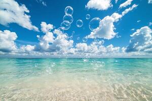 Bubbles floating in the ocean on a sunny day photo