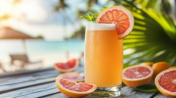 A glass of orange juice with grapefruit slices on a wooden table photo