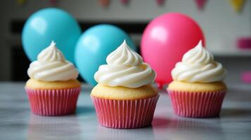 Three cupcakes with frosting on a table photo