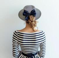 A woman in a striped dress and hat photo