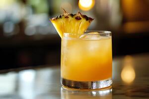 A drink with a pineapple garnish sitting on a bar photo