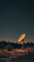 An antenna is sitting in the middle of a field photo