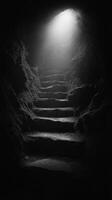 A dark tunnel with steps leading to a light photo