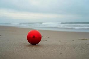 A red ball on the beach photo