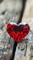 A red diamond heart on a wooden surface photo