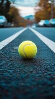 A tennis ball on the road photo