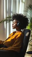 A woman wearing headphones sits in a chair photo