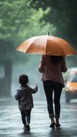 A woman and a child walking in the rain photo