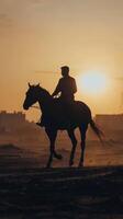 A man riding a horse in the desert photo