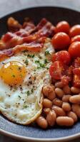 A plate with eggs, beans, tomatoes and bacon photo