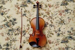 A violin and bow on a floral wallpaper photo