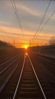 A train track with the sun setting behind it photo