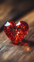A red diamond heart on a wooden table photo